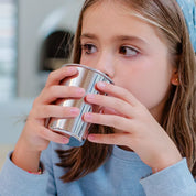 Young girl drinking from a 10 oz stainless steel cup. The perfect sized cup for bigger kids, easy to clean, dishwasher safe, and durable. 